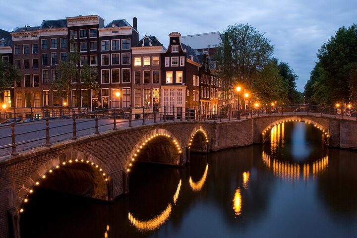 Lit bridges over the Keizersgracht canal in Amsterdam at dusk